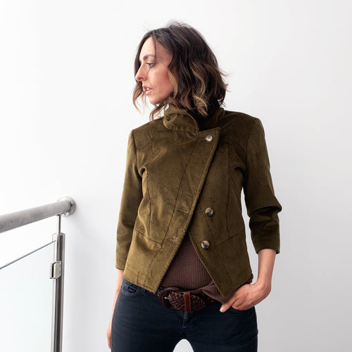 Our iconic Elena - sustainable and ethical olive green velvet cord cropped and fitted jacket is full of drama. Its oversized funnel neck, tapered waist and bracelet sleeve are perfect for smart days and glamorous evenings. Impress yourself, then the world. Designed in Scotland. Made in Italy. Limited editions: Olive 3/3